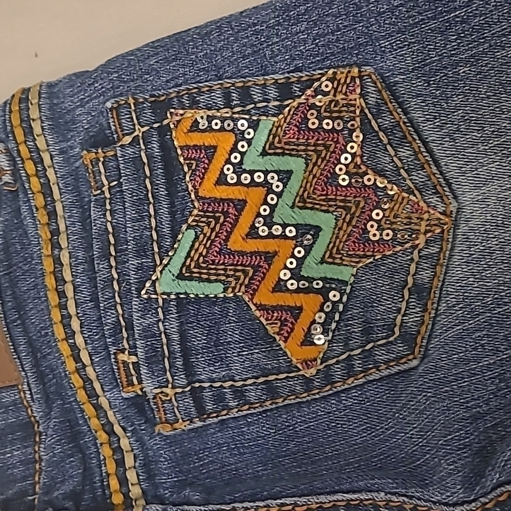 Vigoss 6X girl jeans with star embellishments on back packets